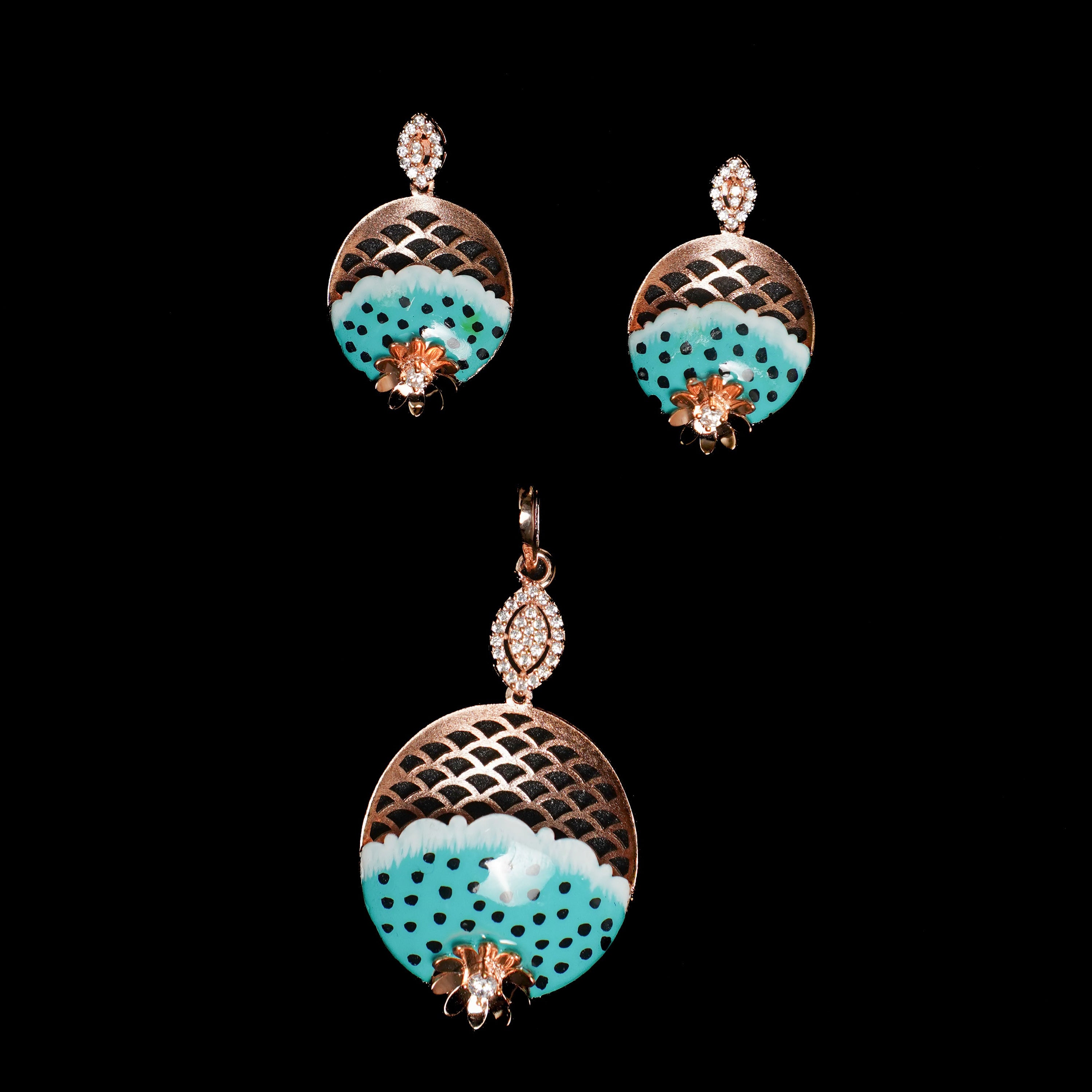 Pair of earrings with turquoise and gold design on a black background